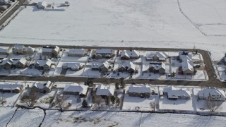 AX126_211 - 5.5K aerial stock footage orbit rows of tract homes with winter snow on rooftops in Midway, Utah