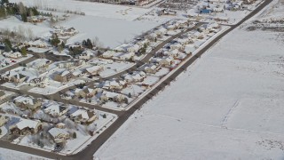 AX126_212 - 5.5K aerial stock footage orbiting rows of tract homes with winter snow in Midway, Utah