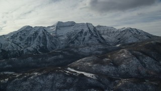 AX126_237 - 5.5K aerial stock footage orbit rugged Mount Timpanogos with winter snow in the Wasatch Range of Utah