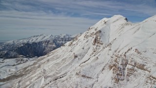 AX126_266 - 5.5K aerial stock footage approach the north end of snowy Mount Timpanogos in winter, Utah
