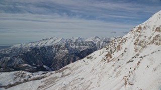 AX126_267E - 5.5K aerial stock footage of Wasatch Range snow mountains and the north end of Mount Timpanogos in Utah