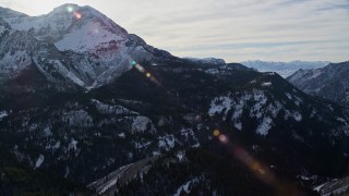 AX126_282E - 5.5K aerial stock footage of north side of Mount Timpanogos with wintertime snow, Utah