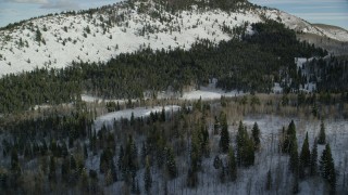 AX126_287 - 5.5K aerial stock footage of flying over evergreen forest with winter snow in Utah's Wasatch Range