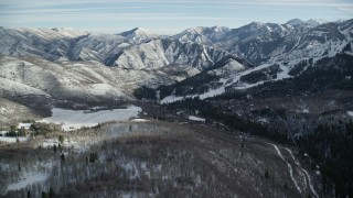AX126_295 - 5.5K aerial stock footage approach Sundance Mountain Resort and distant snow mountains in Utah