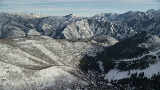 AX126_298 - 5.5K aerial stock footage fly over Sundance Resort and approach Wasatch Range mountains with light snow, Utah
