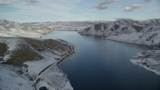 AX126_308 - 5.5K aerial stock footage of flying over Deer Creek Reservoir toward Heber City in winter, Utah