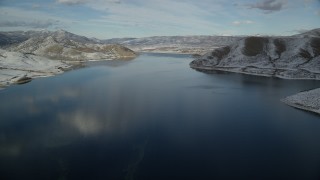AX126_310 - 5.5K aerial stock footage approach Heber City while flying over Deer Creek Reservoir in winter, Utah