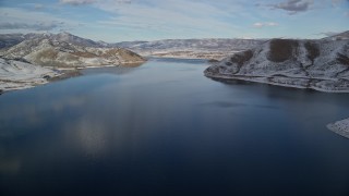 AX126_310E - 5.5K aerial stock footage approach Heber City while flying over Deer Creek Reservoir in winter, Utah
