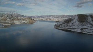 AX126_311 - 5.5K aerial stock footage approach Heber City on the shore of the Deer Creek Reservoir in winter, Utah