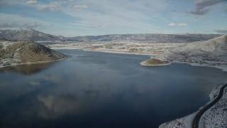 AX126_314 - 5.5K aerial stock footage approach Heber City on the icy shore of Deer Creek Reservoir in winter, Utah