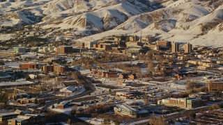 AX127_081E - 5.5K aerial stock footage of University of Utah Hospital with winter snow at sunset, Salt Lake City