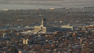 AX127_083 - 5.5K aerial stock footage of Utah State Capitol with snow on the ground at sunset, Salt Lake City