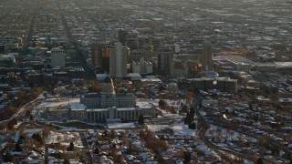 AX127_090E - 5.5K aerial stock footage orbit Utah State Capitol and downtown with winter snow at sunset, Salt Lake City