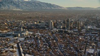 AX127_092 - 5.5K aerial stock footage orbit the Utah State Capitol and Downtown Salt Lake City buildings with winter snow at sunset