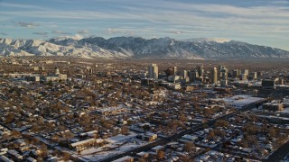 AX127_093 - 5.5K aerial stock footage orbit of the Utah State Capitol and Downtown Salt Lake City with winter snow at sunset