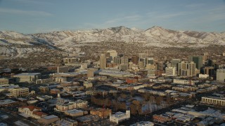 AX127_113 - 5.5K stock footage aerial video of wide orbit of Downtown Salt Lake City with winter snow at sunset, Utah