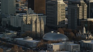 AX127_118 - 5.5K stock footage aerial video orbit Salt Lake Temple and Tabernacle at sunset with winter snow, Salt Lake City, Utah