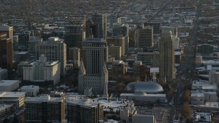 AX127_122 - 5.5K stock footage aerial video of Salt Lake Temple and Tabernacle in downtown with winter snow at sunset, Utah