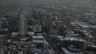 AX127_123 - 5.5K stock footage aerial video orbit Joseph Smith Building, Salt Lake Temple and Tabernacle in downtown with winter snow at sunset, Utah