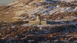 AX127_128 - 5.5K aerial stock footage of reverse view of Utah State Capitol from downtown with winter snow at sunset, Salt Lake City