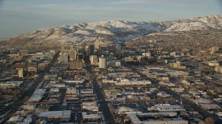 AX127_133 - 5.5K stock footage aerial video approach Main and State Streets through Downtown Salt Lake City, Utah, sunset in winter