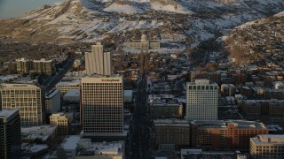 AX127_138 - 5.5K stock footage aerial video approach Utah State Capitol at the end of State Street at sunset with winter snow, Salt Lake City