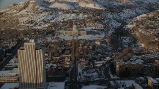 AX127_139 - 5.5K stock footage aerial video fly over State Street toward Utah State Capitol with winter snow at sunset, Salt Lake City