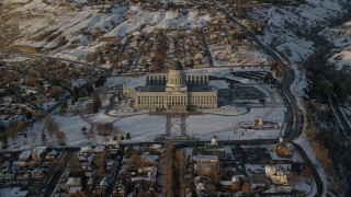 AX127_140 - 5.5K stock footage aerial video approach Utah State Capitol Building at sunset with winter snow, Salt Lake City
