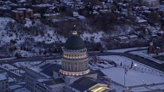 AX128_013E - 5.5K aerial stock footage orbit dome of state capitol at twilight with winter snow on ground, Salt Lake City, Utah