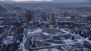 AX128_022 - 5.5K stock footage aerial video approach Utah State Capitol, Church Office Building and the temple in Downtown SLC at twilight