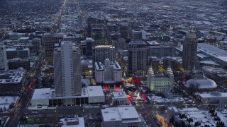 AX128_024 - 5.5K stock footage aerial video fly over Salt Lake Temple in Downtown SLC and approach Main Street in winter at twilight, Utah