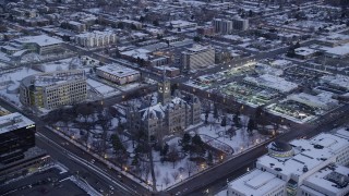 AX128_027 - 5.5K stock footage aerial video orbit Salt Lake City Hall with winter snow at twilight, Utah