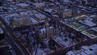 AX128_027E - 5.5K aerial stock footage of Salt Lake City Hall with winter snow at twilight, Utah