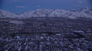AX128_029 - 5.5K aerial stock footage of suburban Neighborhoods and Liberty Park with winter snow at twilight, Salt Lake City, Utah