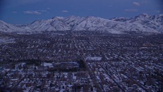 AX128_030 - 5.5K aerial stock footage of Salt Lake City suburban neighborhoods near Liberty Park with winter snow at twilight, Utah