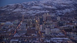 AX128_036E - 5.5K aerial stock footage of Utah State Capitol and downtown with winter snow seen from southeast of Salt Lake City at twilight