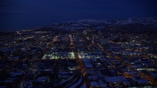 AX128_069E - 5.5K aerial stock footage approach downtown, fly over West Temple toward State Street, Downtown SLC, Utah with winter snow at night