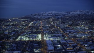 AX128_070 - 5.5K aerial stock footage fly over West Temple toward State Street, Downtown SLC, Utah with winter snow at night