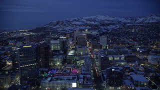 AX128_073 - 5.5K aerial stock footage of following State Street through Downtown SLC and approach capitol with winter snow at night, Utah