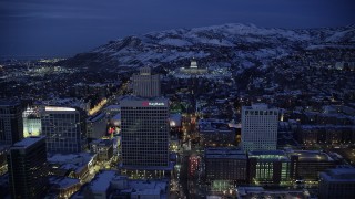 AX128_074 - 5.5K stock footage aerial video approach Utah State Capitol at end of State Street from Downtown SLC with winter snow at night