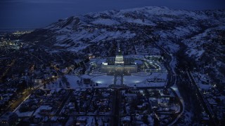 AX128_075 - 5.5K stock footage aerial video approach Utah State Capitol with winter snow at night, Salt Lake City