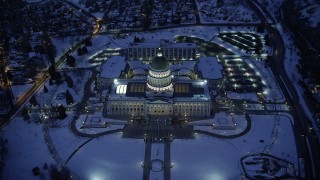 AX128_076 - 5.5K stock footage aerial video tilt to bird's eye view of the Utah State Capitol with winter snow at night, Salt Lake City
