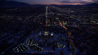 AX128_078E - 5.5K aerial stock footage fly over Utah State Capitol and approach State Street through Downtown SLC in winter twilight