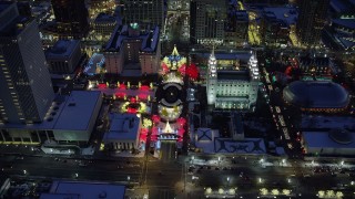 AX128_084 - 5.5K stock footage aerial video orbit Salt Lake Temple with Christmas lights and winter snow at night, Downtown Salt Lake City, Utah
