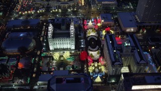 AX128_087 - 5.5K stock footage aerial video orbit Salt Lake Temple with Christmas lights and winter snow at night in Downtown Salt Lake City, Utah