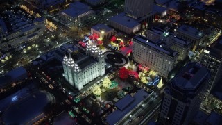 AX128_088 - 5.5K stock footage aerial video orbit Salt Lake Temple decorated for Christmas with snow at night, Downtown Salt Lake City, Utah