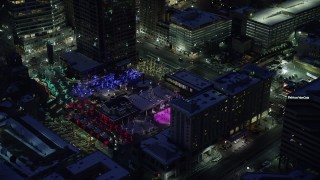 AX128_092 - 5.5K stock footage aerial video orbit Christmas tree at Gallivan Center with winter snow at night, Downtown Salt Lake City, Utah