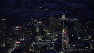 AX128_099 - 5.5K stock footage aerial video of the Capitol at end of State Street to reveal Main Street in winter at night, Downtown Salt Lake City, Utah