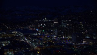 AX128_101E - 5.5K aerial stock footage of the Utah State Capitol by Downtown Salt Lake City in winter at night