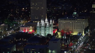 AX128_105 - 5.5K stock footage aerial video orbit Salt Lake Temple with Christmas lights at night in wintertime, Downtown Salt Lake City, Utah